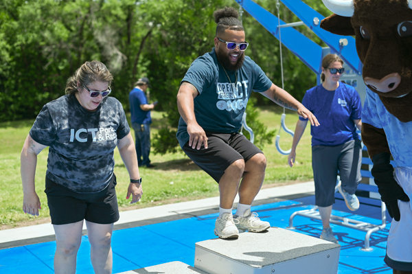 three people exercise on a Kansas Fitness Court