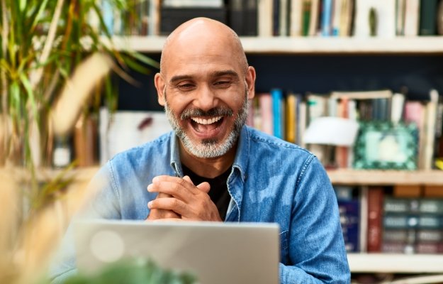 Happy man looking at computer