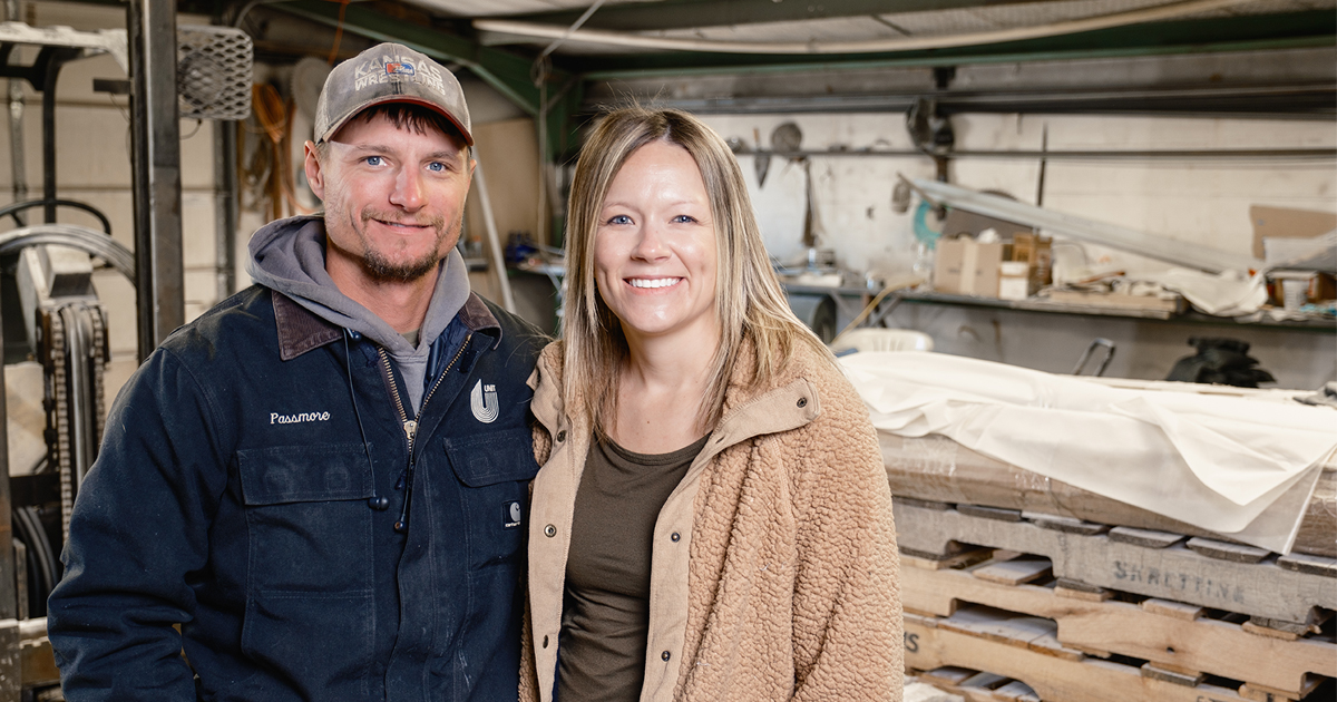 A man and woman stand in a workshop