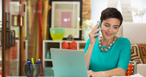 A woman on her mobile phone in a colorful office