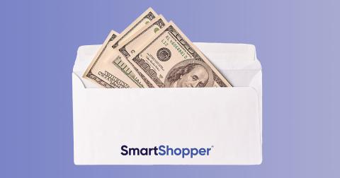 Four one hundred dollar bills sticking out of a Smart Shopper envelope